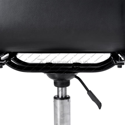 Close-up of a black leather chair with a metal base on a white background KANTORKU.co.id Solusi Tepat Kebutuhan Kantor Kamu!!